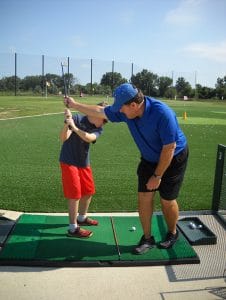 camper learning to golf at camp mirage